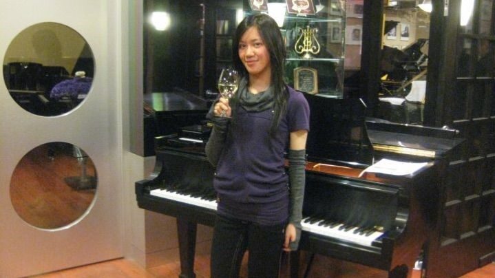 BAH Piano Teacher Josie with a Steinway Piano at a Reception