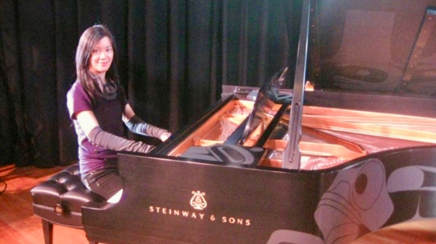 BAH piano teacher Josie with a Steinway Piano with First Nations Artwork